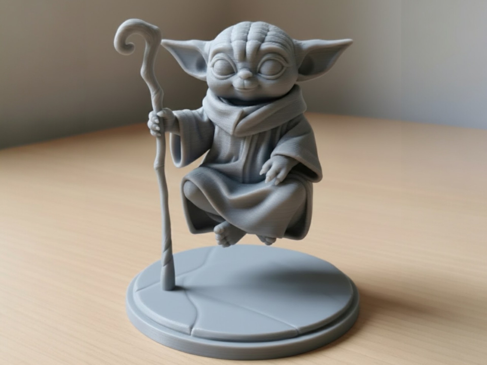A finely detailed 3D-printed figurine standing on a desk.