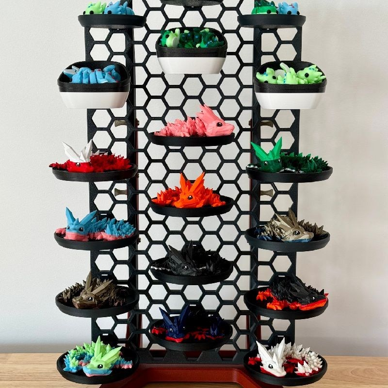 A honeycomb wall rack displaying rows of 3D-printed miniature sneakers.
