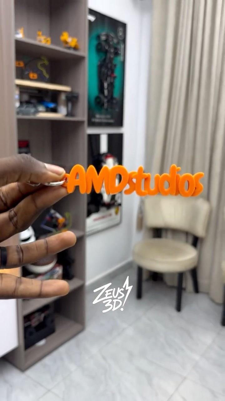 A 3D-printed name and logo display.
