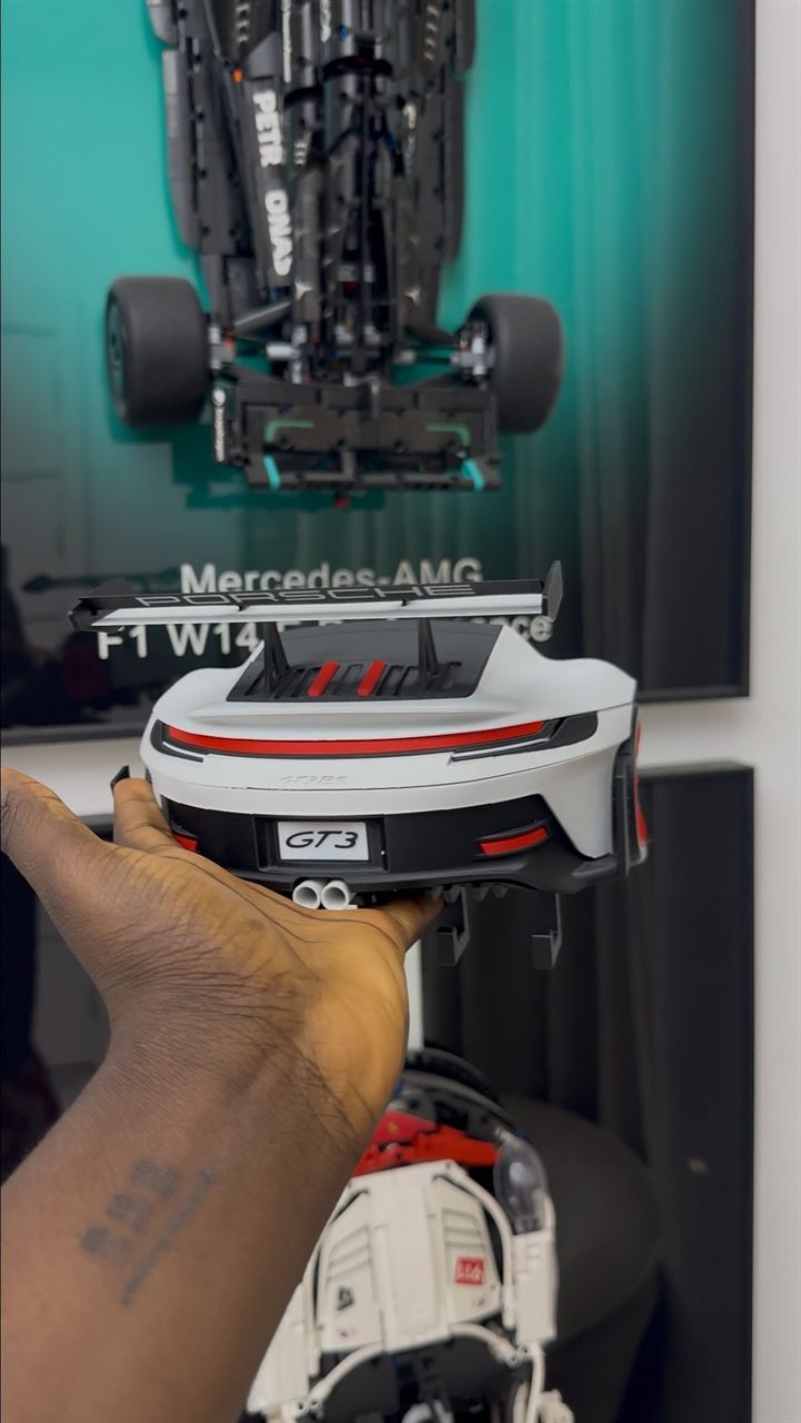 A 3D-printed Formula 1 car model held in hand.